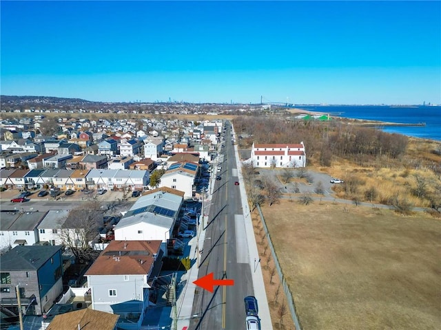 birds eye view of property with a water view and a residential view