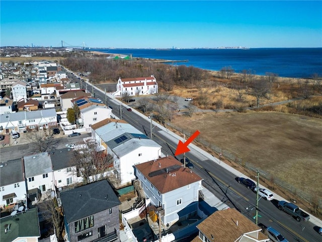 birds eye view of property with a water view and a residential view