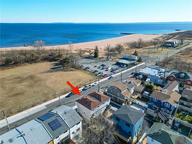 drone / aerial view featuring a water view and a view of the beach