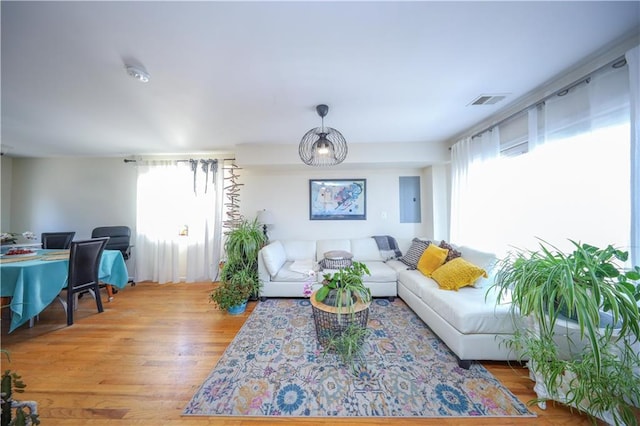 living room featuring plenty of natural light, wood finished floors, and visible vents