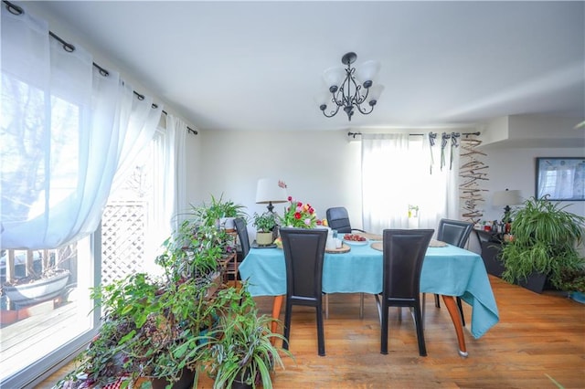 dining space featuring a chandelier and wood finished floors