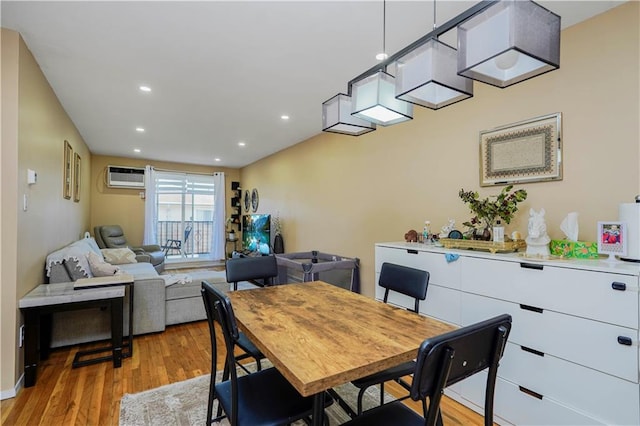 dining space with recessed lighting, light wood-style flooring, and a wall mounted AC