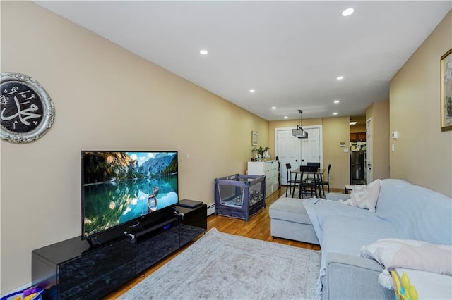 living room featuring baseboard heating, recessed lighting, and wood finished floors