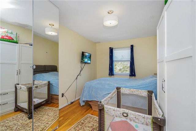 bedroom featuring wood finished floors and baseboards