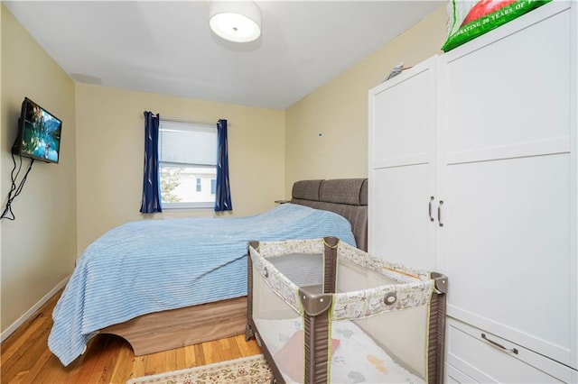 bedroom with wood finished floors and baseboards