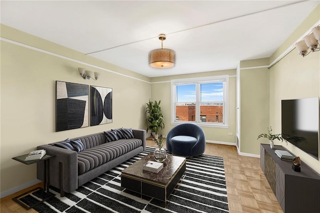 living area featuring baseboards