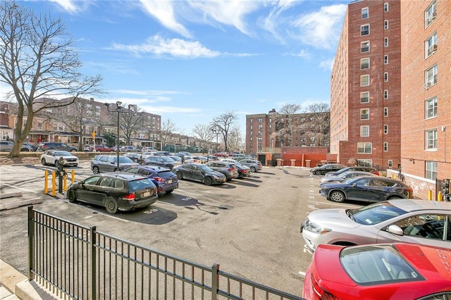 uncovered parking lot featuring fence