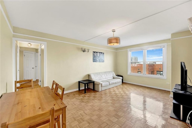 living area featuring baseboards