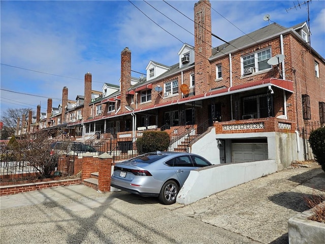 view of property with an attached garage and brick siding