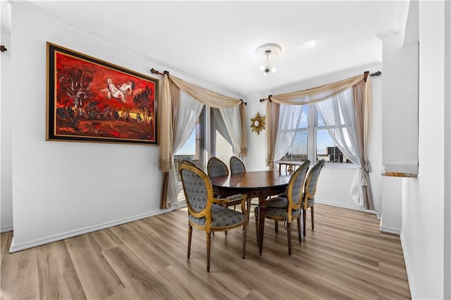 dining room with baseboards and wood finished floors