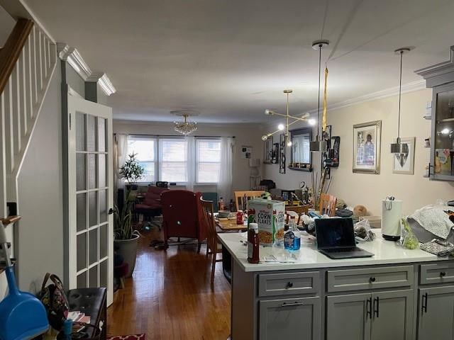 2195 Linden Blvd, Brooklyn, NY 11207 - kitchen featuring gray cabinets, ornamental molding, dark wood finished floors, light countertops, and hanging light fixtures