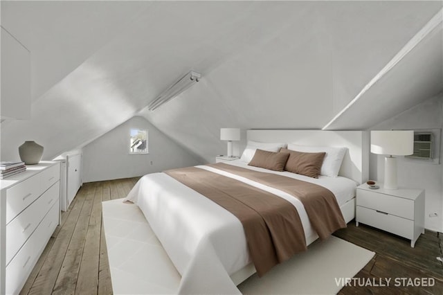 bedroom with lofted ceiling and light wood-type flooring