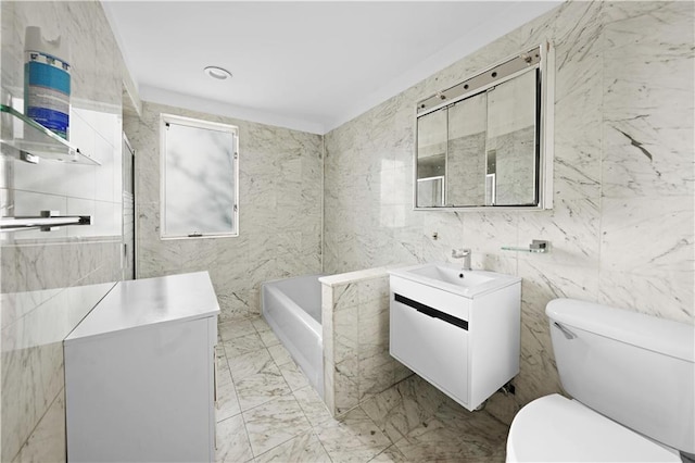 full bathroom featuring a washtub, marble finish floor, vanity, and toilet