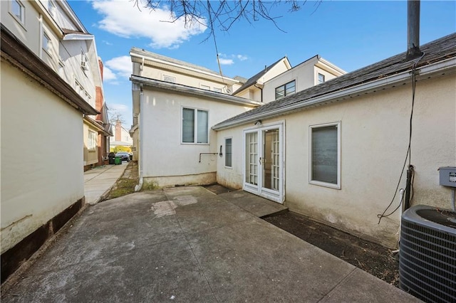 back of property featuring central AC, french doors, a patio area, and stucco siding