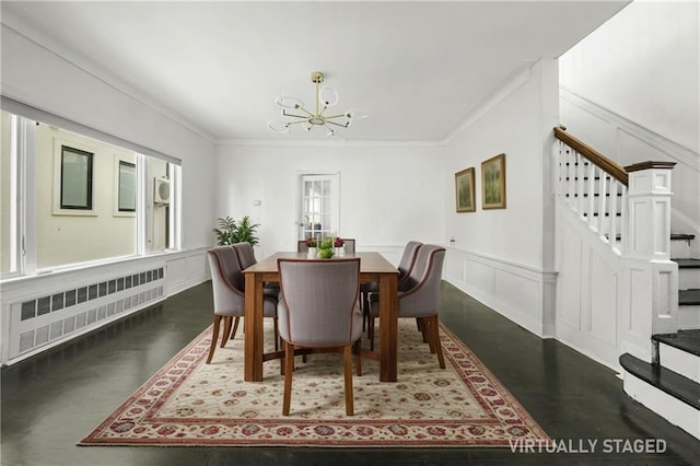 dining room with crown molding, a notable chandelier, radiator, a decorative wall, and stairway