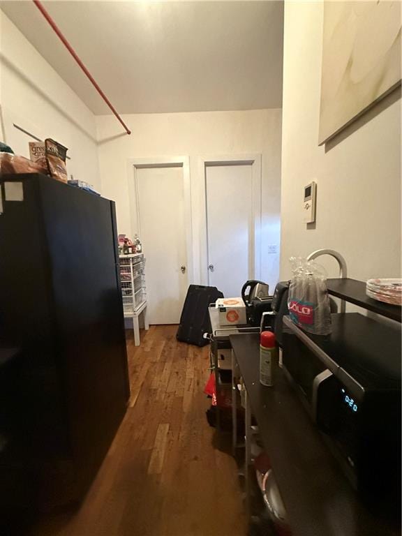 kitchen featuring wood finished floors and freestanding refrigerator