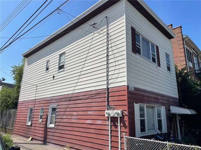 view of home's exterior with fence