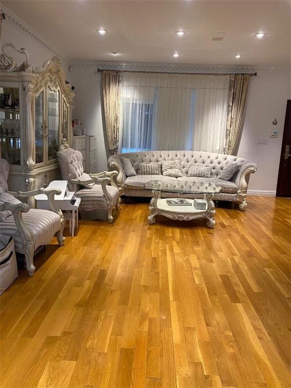 living area with recessed lighting and wood finished floors