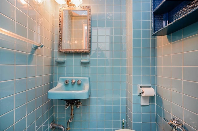 half bathroom with tile walls