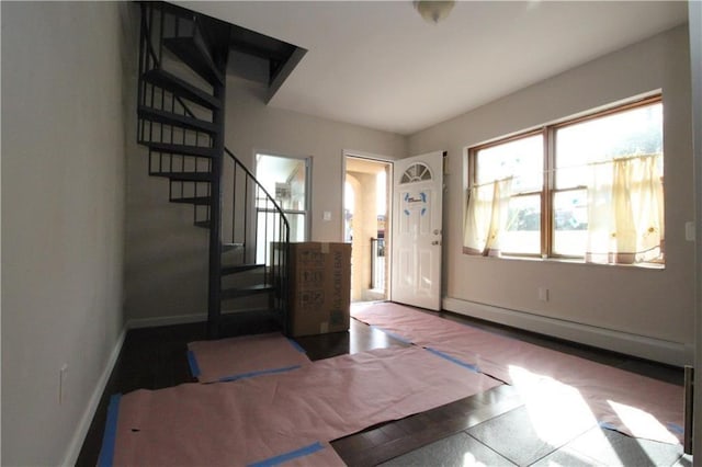 foyer with stairs and baseboards