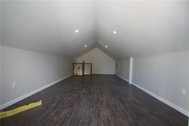additional living space with recessed lighting, baseboards, dark wood finished floors, and lofted ceiling