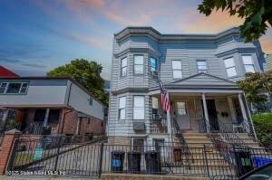 31 Seeley St, Brooklyn, NY 11218 - townhome / multi-family property featuring a porch and a fenced front yard
