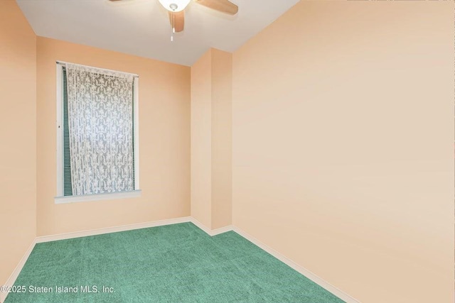 carpeted empty room featuring a ceiling fan and baseboards