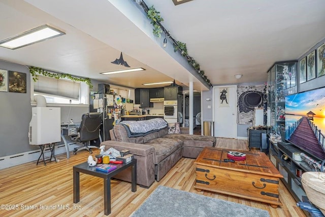 31 Seeley St, Brooklyn, NY 11218 - living room with light wood-style floors and a desk