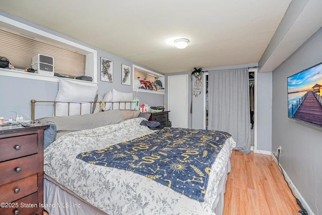 31 Seeley St, Brooklyn, NY 11218 - bedroom featuring light wood finished floors, baseboards, and a closet