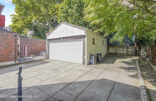 detached garage featuring fence