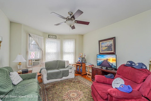 living room with cooling unit, ceiling fan, and wood finished floors