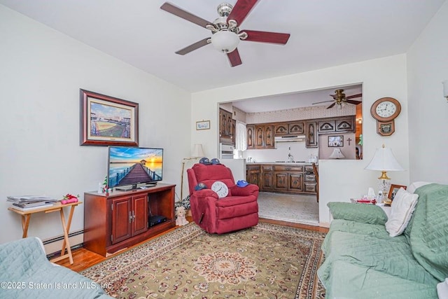31 Seeley St, Brooklyn, NY 11218 - living area featuring a ceiling fan, wood finished floors, and baseboard heating
