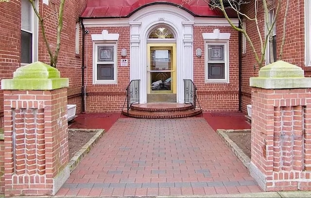 entrance to property with brick siding