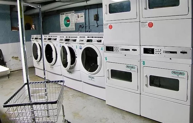 community laundry room with stacked washer and dryer and washer and clothes dryer