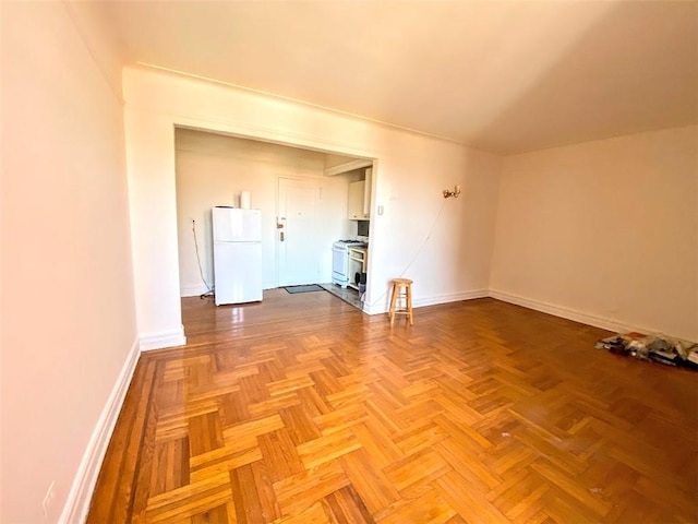 spare room featuring baseboards