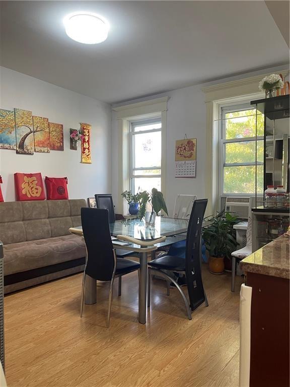 dining room featuring light wood finished floors and cooling unit