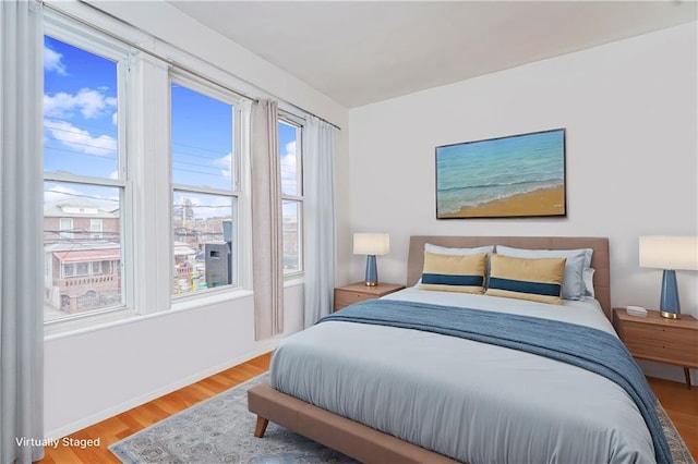 bedroom featuring baseboards and wood finished floors