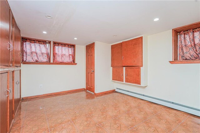 empty room with recessed lighting, baseboards, and a baseboard radiator