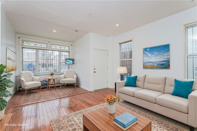 living room featuring recessed lighting, baseboards, a healthy amount of sunlight, and hardwood / wood-style flooring