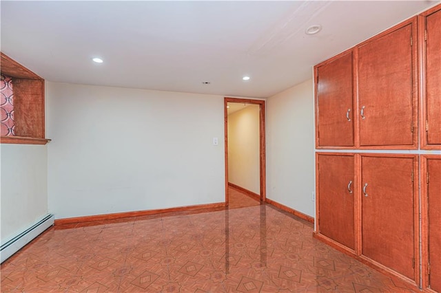 empty room with recessed lighting, a baseboard radiator, and baseboards