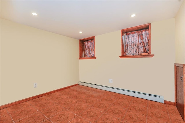 empty room featuring recessed lighting, baseboards, and baseboard heating