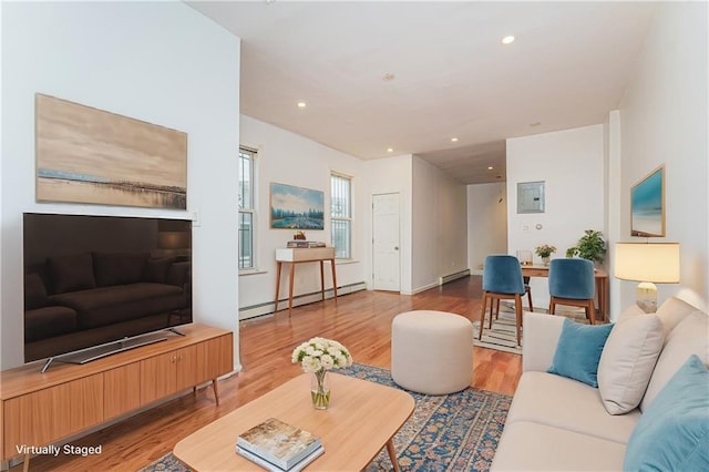 living area featuring recessed lighting, a baseboard heating unit, and wood finished floors