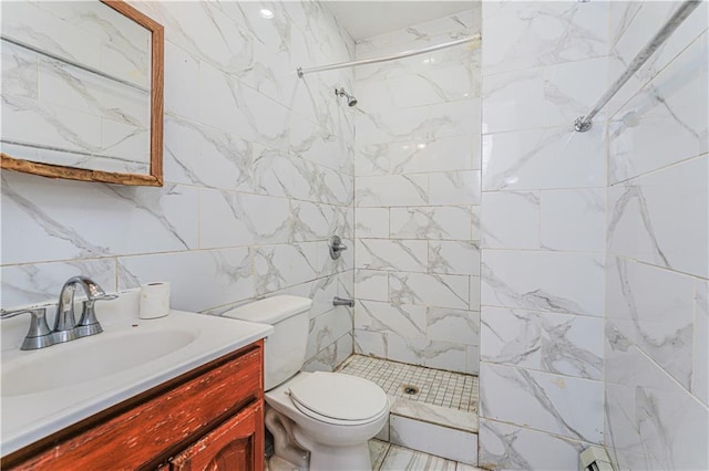 bathroom with toilet, backsplash, a tile shower, tile walls, and vanity