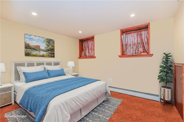 bedroom with recessed lighting and a baseboard heating unit