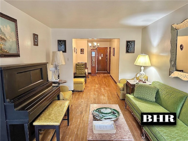 living room featuring wood finished floors and a notable chandelier