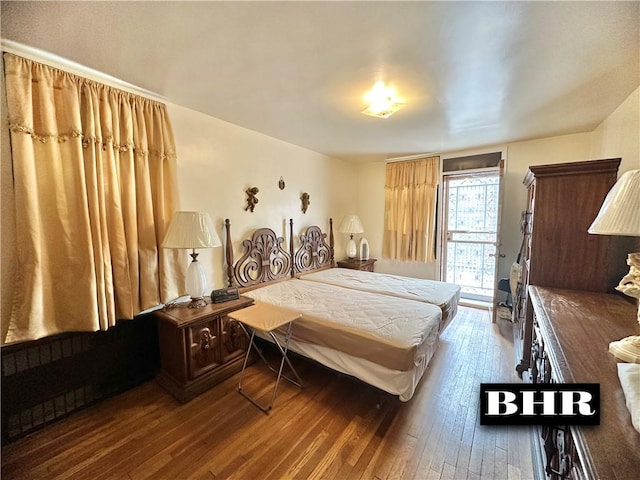 bedroom featuring access to outside and hardwood / wood-style flooring