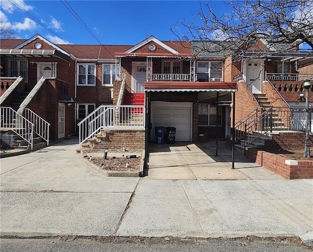 view of front of house featuring an attached garage, concrete driveway, and brick siding