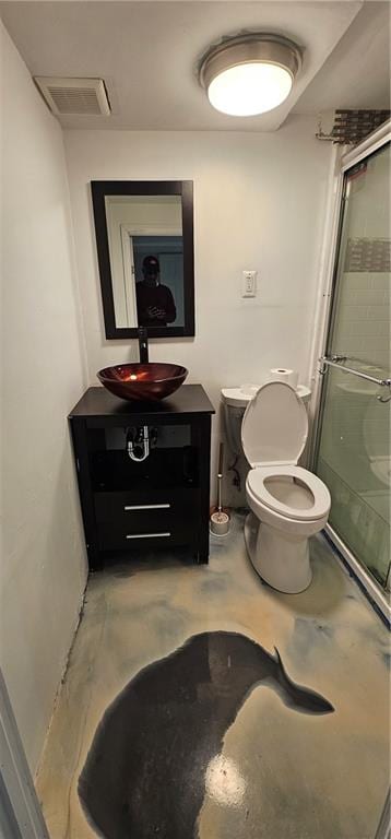 bathroom featuring visible vents, toilet, a stall shower, vanity, and concrete floors