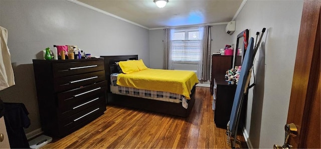 bedroom featuring a wall unit AC, ornamental molding, and wood finished floors