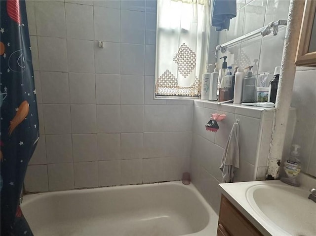 bathroom with shower / bathtub combination with curtain, vanity, and a healthy amount of sunlight